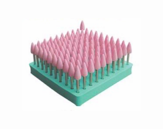 Pink abrasive mounted points set in various shapes, used for polishing and grinding metals