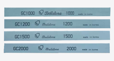 Precision polishing stones in different colors, indicating varying abrasive properties and applications
