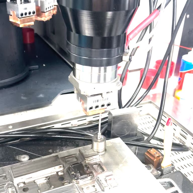 A Sinker EDM machine for creating complex cavities and shapes in hard metals, commonly used in die and mold making.