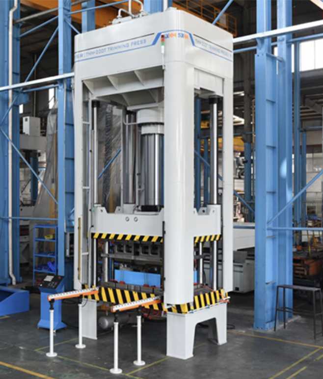 An industrial trimming press for trimming excess material and flash from molded plastic and metal parts.