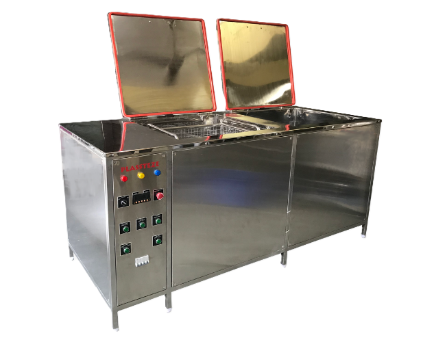 An industrial ultrasonic cleaner with a stainless steel tank, used for deep cleaning small parts and tools.